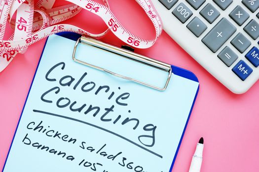 Calorie counting list for weight loss on desk.