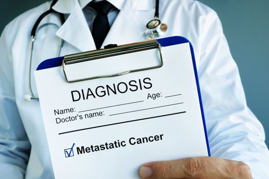 Diagnosis Metastatic cancer in a medical form with clipboard.