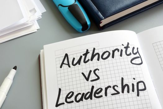 Authority vs Leadership sign in the notebook. Types of management.