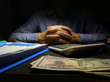 Bad credit or Payday loans. Man at the desk and money.