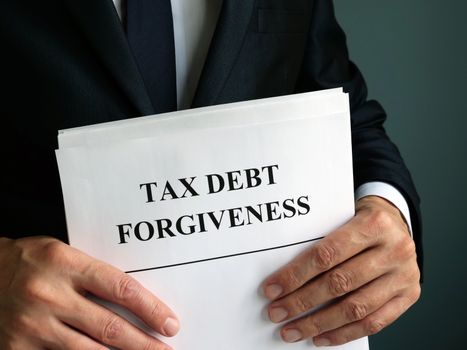 Man holds Tax debt forgiveness agreement.