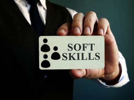 Soft skills sign in the hands of a man.