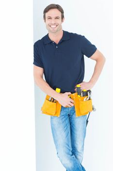 Man with tool belt around waist against white background