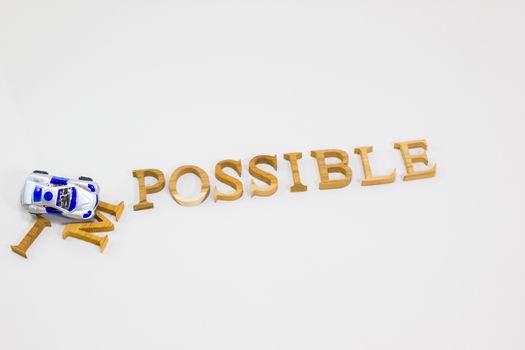 Changing the word impossible to possible with crashing car toy. 