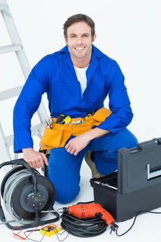 Confident electrician with tools