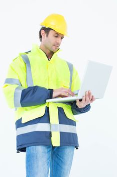 Architect in reflective clothing using laptop computer