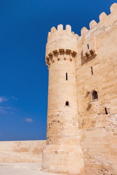 Tower and wall of citadel of Qaitbay fortress. Antique landmark in Alexandria, Egypt.