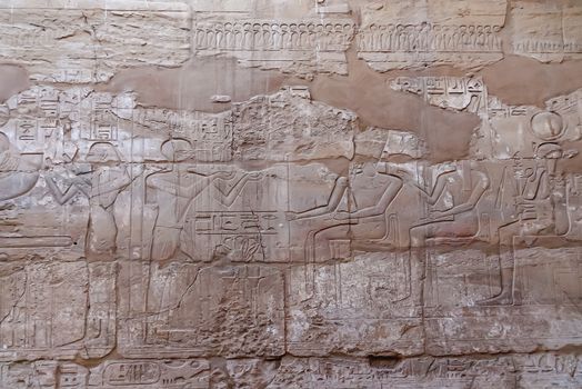 Hieroglyphs on wall of Karnak Temple Complex, famous architectural landmark in Luxor, Egypt.