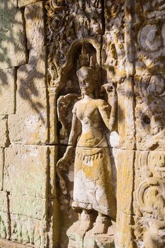 Apsara dancers carved in stone, all around on the walls at Angkor Wat (largest religious temple complex monument in the world). Siem Reap, Cambodia. UNESCO World Heritage Site.