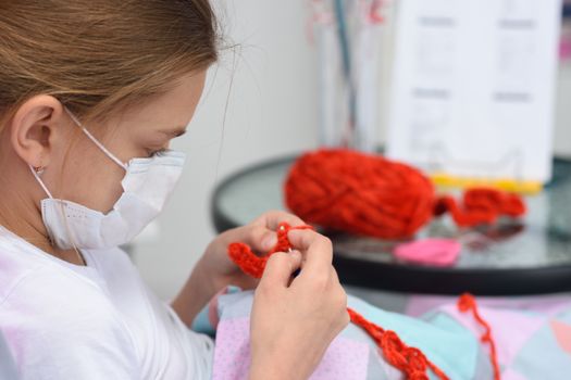 Sick girl crochets a lying in bed