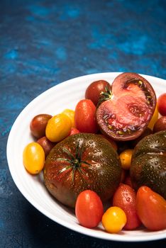 Vibrant Organic Tomatoes on Plate. Market Fresh Vegan Food. Plant Food Diet.