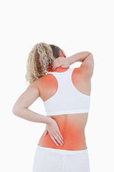 Blonde woman touching her neck and back as an indication of pain