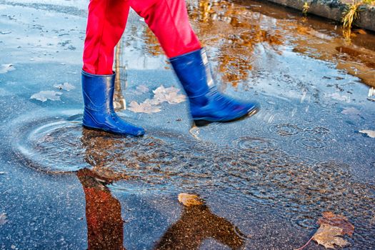 girl standing in a puddle of water splashes
