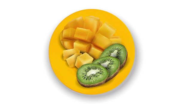 Composition of kiwi slices and diced mango on a yellow plate.