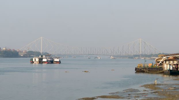 Panoramic Scenics Howrah bridge over Hooghly river. Photography in winter sunset from Babu Ghat Calcutta Riverside Area Kolkata, West Bengal, India, South Asia Pac January 2020
