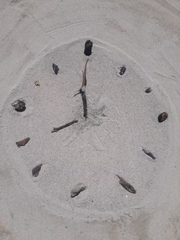Sand and stick beach clock face 8 o clock