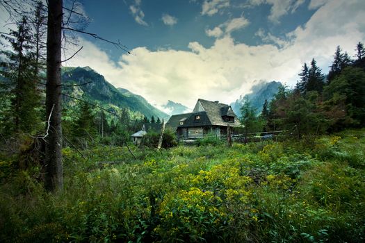 Nature in mountains. Old wooden house in beautiful mountains scenery.