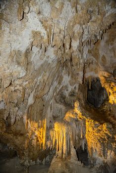 Calcite inlets, stalactites and stalagmites in large underground