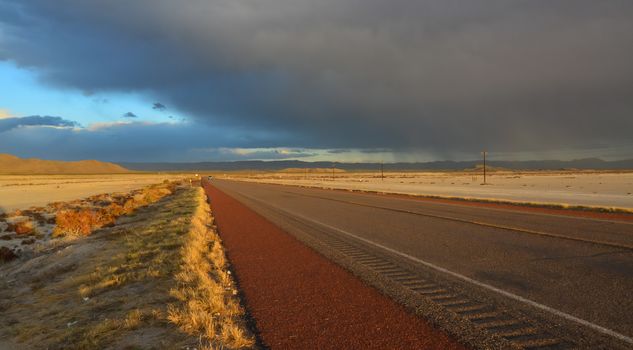 Roads during a red sunset and thunderclouds against