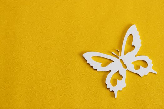 White butterflies on a yellow background, a creative minimal concept, copy space.