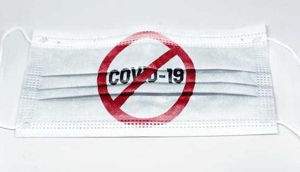 surgical mask with the prohibition red sign to Coronavius covid-19 printed.