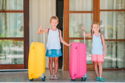Kids with two luggages ready to travel