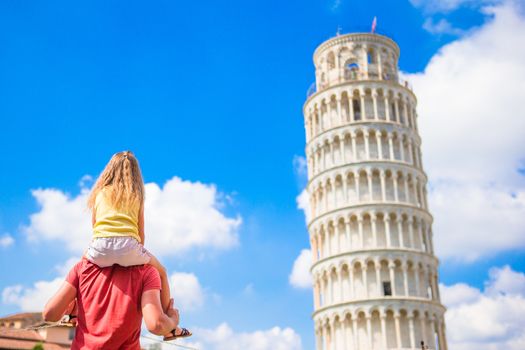 Family of father and little kid background the Learning Tower in Pisa. Pisa - travel to famous places in Europe.