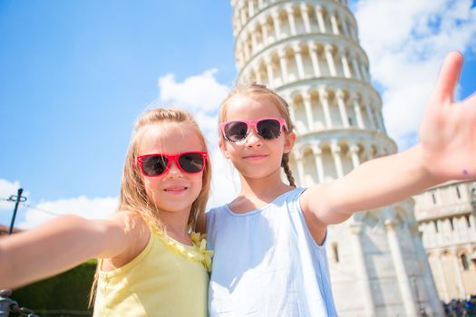 Little kids taking selfie background the Leaning Tower in Pisa, Italy. Photo about european vacation