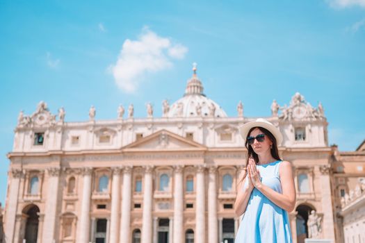 Happy young woman in Vatican city and St. Peter's Basilica church, Rome, Italy.