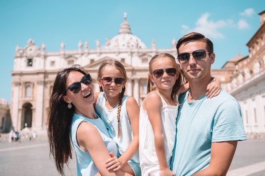 Happy family at St. Peter's Basilica church in Vatican city.