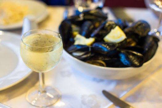 Mussel with white wine sauce at plate on table