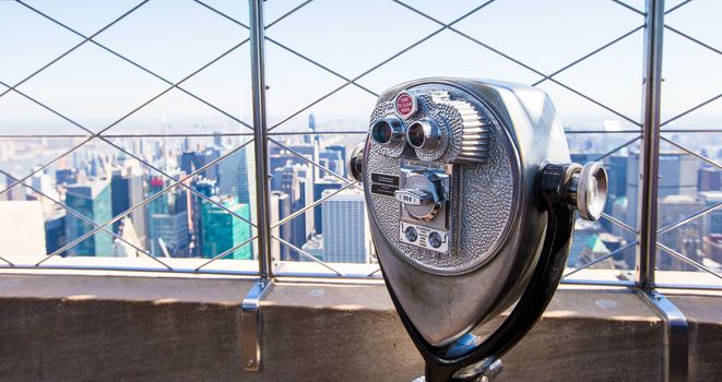 Public telescope pointed on Manhattan buildings