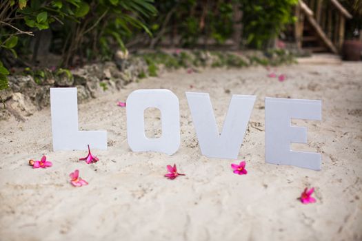 Word love on sandy beach at beautiful resort