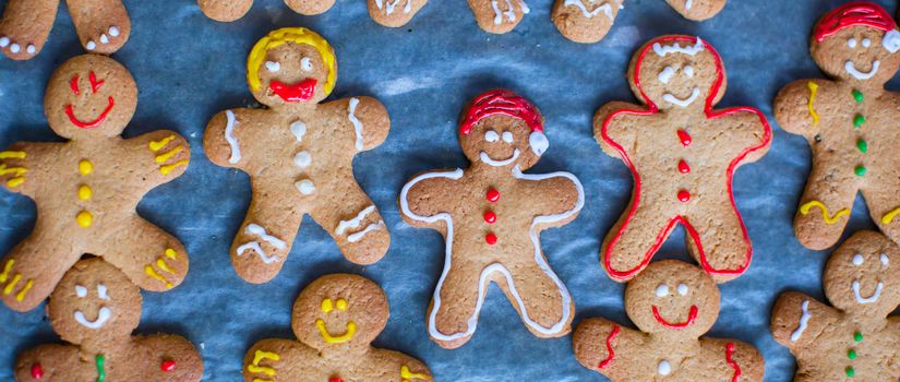 Colorful gingerbread men on baking sheet for Christmas time