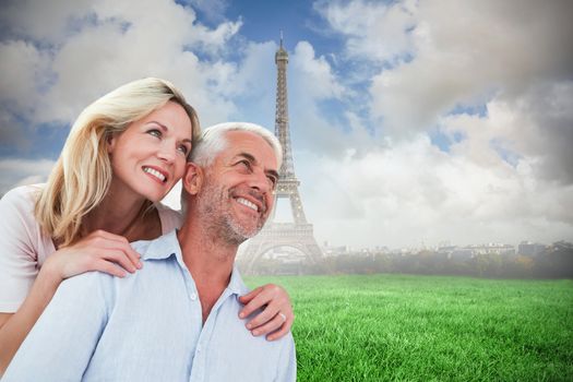 Composite image of smiling couple embracing and looking 