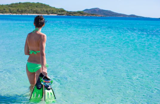 Young beautiful woman with snorkel in blue sea
