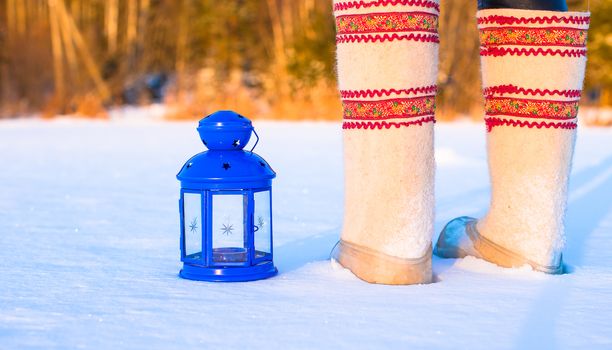 Closeup of beautiful vintage blue Christmas lantern on the snow