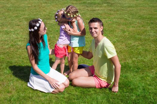 Happy family with two children outdoors on summer day