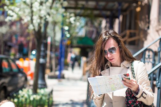Young woman with map in historic district of West Village