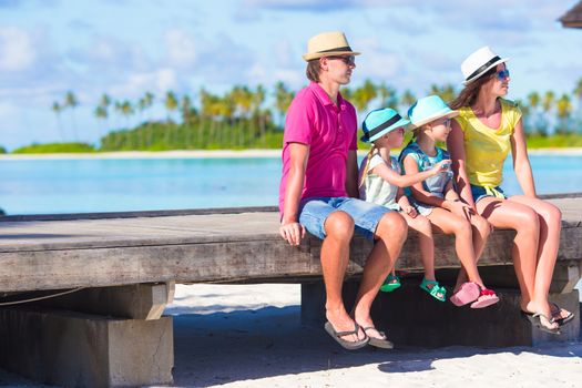 Family of four on wooden jetty at Maldives