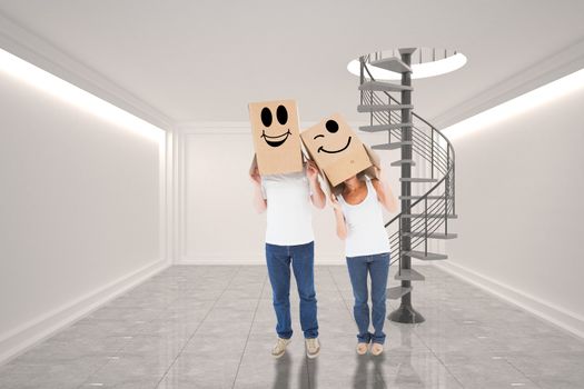 Composite image of mature couple wearing boxes over their heads