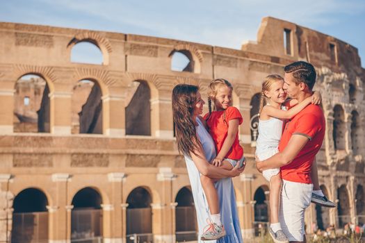 Happy family in Rome over Coliseum background.
