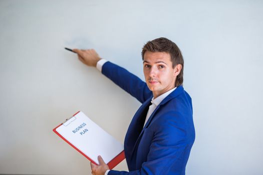 Young businessman with business plan and financial documents