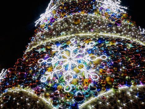 Colorful christmas tree with glowing decorations at Wroclaw market square