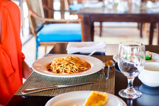 Spaghetti a la Bolognese in the white plate.
