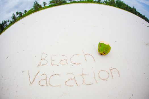 Holidays summer concept. The word beach vacation written on the sand