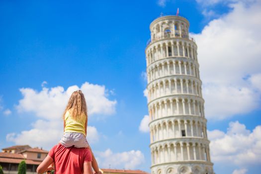 Family of dad and kid background the Learning Tower in Pisa. Pisa - travel to famous places in Europe.