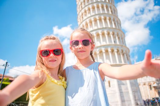 Little tourists girls taking selfie background the Leaning Tower in Pisa, Italy. Photo about european vacation
