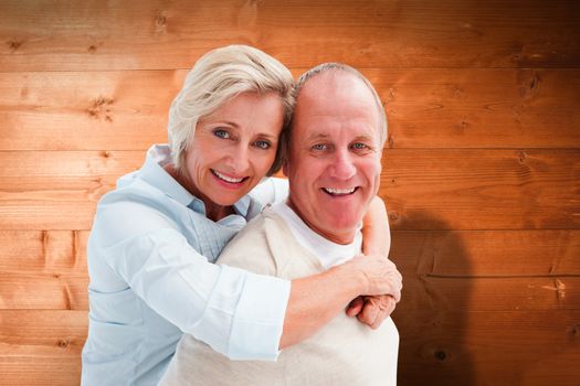 Composite image of happy mature couple smiling at camera