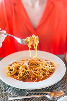 Spaghetti a la Bolognese in the white plate.